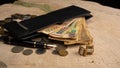 Old coins, fountain pen, wallet, cufflinks and more on a rustic wooden surface, selective focus Royalty Free Stock Photo