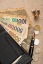 Old coins, fountain pen, wallet, cufflinks and more on a rustic wooden surface, selective focus Royalty Free Stock Photo