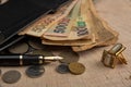 Old coins, fountain pen, wallet, cufflinks and more on a rustic wooden surface, selective focus Royalty Free Stock Photo