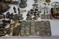 Old coins and metallic vintage objects presented on an antics market`s table