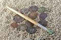 Old coins sand brush Royalty Free Stock Photo