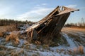 Old collapsed barn in December winter sunlight Royalty Free Stock Photo
