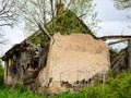 Old and collapsed country house, collapsed wall and old wooden logs Royalty Free Stock Photo