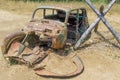 Old collapsed retro car thrown on a rusty field after the war. Royalty Free Stock Photo