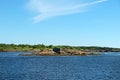 Old collapsing barn on the stone shore Royalty Free Stock Photo