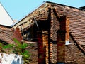 old deteriorating and collapsing house detail. broken and leaning brick chimney