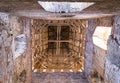 Old collapsing tower brick with arches windows, perspective from below upwards wooden roof, mystical walk through abandoned