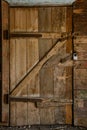 Old collapsing wooden door with rusty hinges Royalty Free Stock Photo