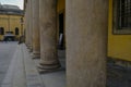 Old colomns close-up across yellow building and old town. Theater Farnese in Parma, Italy Royalty Free Stock Photo