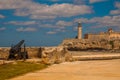 The old colonial castle of San Salvador de la Punta. Gun at the walls of the ruined. Castillo Del Morro lighthouse. Havana, Cuba. Royalty Free Stock Photo