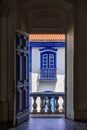 Old colonial houses seen through the door of historic church Royalty Free Stock Photo