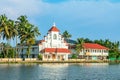 Old colonial Saint Thomas catholic church on the coast of Pamba river, with palms, Alleppey, Kerala, South India Royalty Free Stock Photo