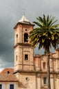 Old colonial stone church tower with palm tree Royalty Free Stock Photo