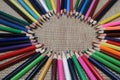 Old color pencils on burlap background Royalty Free Stock Photo