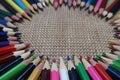 Old color pencils on burlap background Royalty Free Stock Photo