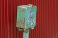 Old color rusty metal box for electricity on a pole outside Royalty Free Stock Photo