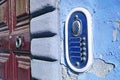 Old colored bell system on blue plaster Royalty Free Stock Photo