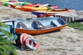 Old colored boats and lifebuoys in the sand on the beach