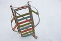 Old colored sledges in the snowdrift of white snow on the street
