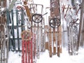 Old colored sledges standing in snowstorm