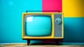 Old colored television and colored wall