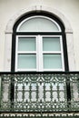 Typical vintage portuguese facade with forged metal balcony