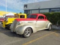 Old colorful 1937 Chevrolet Master coupe street rod in a parking lot at a classic car show. Royalty Free Stock Photo