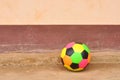 Old colorful football on cement floor