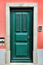 Old and colorful green wooden door with iron details Royalty Free Stock Photo