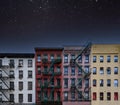 Old colorful New York City apartment buildings with a star filled night sky above Royalty Free Stock Photo