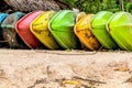 Old colorful plastic boat green and yellow lies on the sandy beach of a tropical island Royalty Free Stock Photo