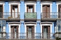 Old colorful residential building in central Madrid with iron balconies and blue stucco facade Royalty Free Stock Photo