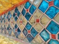 Old colorful tiles decorated on the concrete wall.