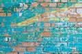 Old colorful turquoise and yellow paint with cracks on red brick wall Royalty Free Stock Photo