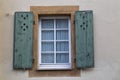 Old colorful window with open wooden shutters on wall of house Royalty Free Stock Photo