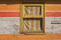 Old colorful wooden wall of a house with a window. Colors of windows and doors Royalty Free Stock Photo