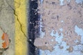 Old yellow blue black paint with cracks on red brick wall as background, texture, selective focus Royalty Free Stock Photo