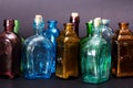 Old colourful bottles against a dark background