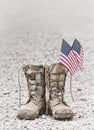 Old combat boots with dog tags and American flags Royalty Free Stock Photo