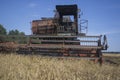 Old combine harvester lighted up on harvesting of the grain 2 Royalty Free Stock Photo