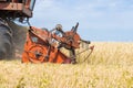 Old combine harvester removes wheat Royalty Free Stock Photo