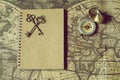 Compass, antique keys and notebook on blur vintage world map, journey concept, copy space Royalty Free Stock Photo