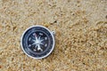 Old compass on beach