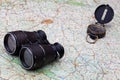 Old compass and binoculars on map