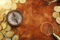 Old compass and gold coins treasure over antique map. top view Royalty Free Stock Photo