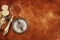 Old compass and gold coins treasure over antique map. top view Royalty Free Stock Photo