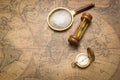 Old compass , magnifying glass and sand clock  on vintage map Royalty Free Stock Photo