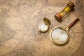 Old compass , magnifying glass and sand clock  on vintage map Royalty Free Stock Photo
