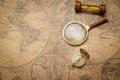 Old compass , magnifying glass and sand clock  on vintage map Royalty Free Stock Photo