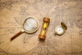 Old compass , magnifying glass and sand clock  on vintage map Royalty Free Stock Photo